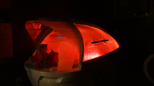 A rich red color emitted by an LED light in a hydrating station.